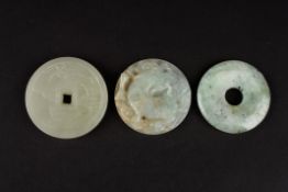 A Chinese 20th Century hardstone pendant of circular form carved in high relief with a dragon