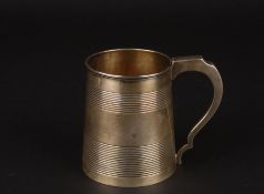 A George III silver tankardhallmarked London 1807, the tapering body with banded decoration, gilded