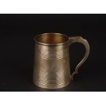 A George III silver tankard
hallmarked London 1807, the tapering body with banded decoration, gilded