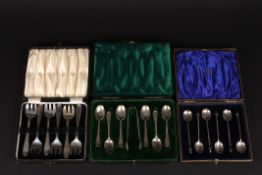 Two cased sets of silver tea spoonstogether with a cased set of silver cake forks. (3), Total