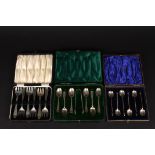 Two cased sets of silver tea spoons
together with a cased set of silver cake forks. (3), Total