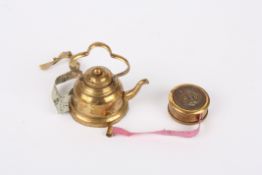 Two novelty vintage tape measuresthe first in the form of a brass kettle, the second of circular