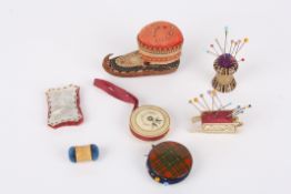A collection of seven Victorian and later pin cushionsincluding one bone example in the form of a