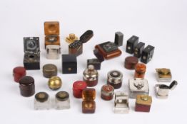 A large collection of mostly Victorian travelling inkwellsincluding a silver and glass square