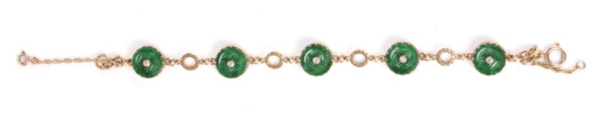A gold, jade and diamond braceletset with five apple green jade roundels, each with carved