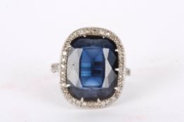 A platinum Art Deco cocktail ringset with large faceted centre sapphire surrounded by numerous