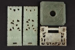 A Chinese 20th century carved square jade panel
carved with a stylised dragon together with a pair