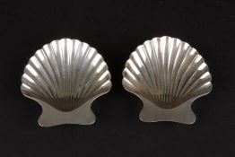 A pair of modern Tiffany Sterling silver shell shaped saltssupported on ball feet, in their
