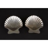 A pair of modern Tiffany Sterling silver shell shaped salts
supported on ball feet, in their