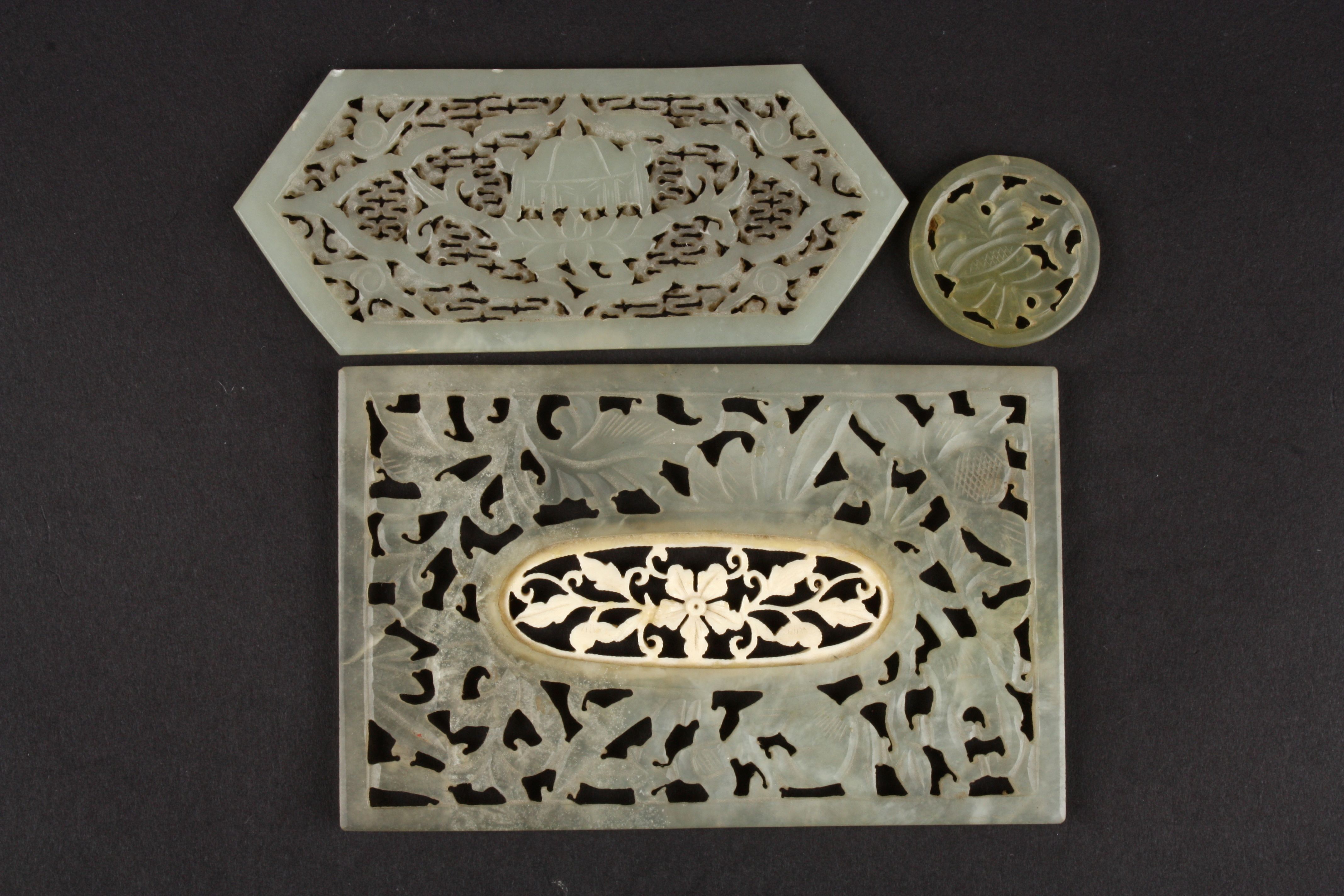 A Chinese 20th century pale jade carved rectangular panel
with central pierced floral inset, another