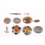 A collection of Victorian and later silver brooches including four Scottish agate brooches, an