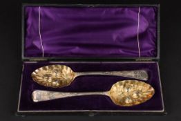 A cased pair of George III silver berry spoonshallmarked London 1814, with gilded embossed bowls