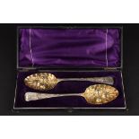 A cased pair of George III silver berry spoons
hallmarked London 1814, with gilded embossed bowls