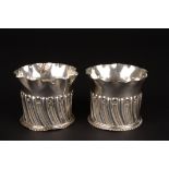A pair of Victorian silver shaped small vases
hallmarked London 1892, with frilled necks and semi-