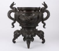 A large late 19th century bronze Japanese jardiniereof quatrefoil form, with twin dragon handles,