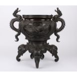 A large late 19th century bronze Japanese jardiniere
of quatrefoil form, with twin dragon handles,