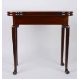 A George II mahogany foldover card table
the shaped top opening to reveal circular carved trays