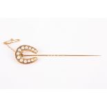 A large Victorian half pearl and rose point diamond horseshoe pin  
with safety chain , length