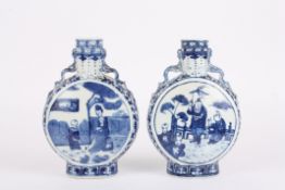 A pair of late 19th century Chinese blue and white moon flask vasesdecorated with central