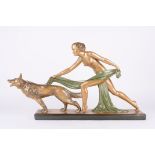A large 1930s Art Deco plaster figure of a nude woman and Alsatian
with bronzed patina, with green