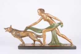 A large 1930s Art Deco plaster figure of a nude woman and Alsatianwith bronzed patina, with green