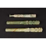 Two 20th century Chinese carved hardstone cigarette holders 
in the form of open mouthed dragons and