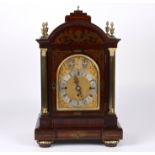 A large late 19th century rosewood musical mantel clock
the gilded arched dial with silvered chapter