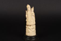 A late 19th century Indian carved ivory figureof two women stood beside an ox and supported on a