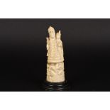 A late 19th century Indian carved ivory figure
of two women stood beside an ox and supported on a