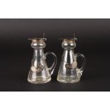 A pair of George V silver topped glass whisky flasks
hallmarked Birmingham 1912, with decanter