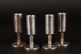 A set of four Irish silver shot glasseshallmarked Dublin 1971, with geometric stems, makers mark: