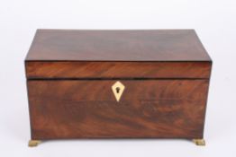 A 19th century mahogany tea caddywith flamed top and ivory escutcheon, opening to reveal a later