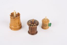 Three treen tape measures comprising one Tunbridgeware measure, another in the form of a turret,