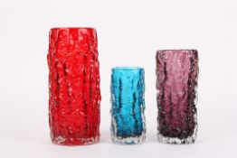 A group of three Whitefriars bark vasesin ruby red, aubergine and kingfisher blue, of differing