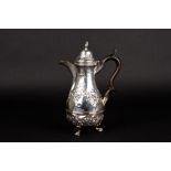 A Victorian silver pear shaped hot water jug
hallmarked Chester 1898, the body embossed with