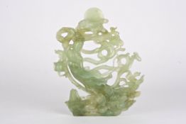 A large carved contemporary Chinese carved jade figure of Quanyinin flowing robes with the moon