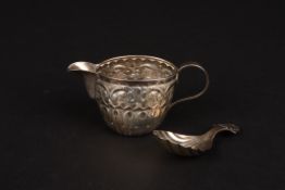 A Victorian repoussé silver jug and a silver caddy spoonthe jug hallmarked Birmingham 1898, the