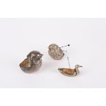 A small collection of three silver pin cushions
the first in the form of large seated bird,