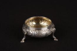 A Victorian embossed circular salthallmarked London 1853, decorated with flowers, and supported