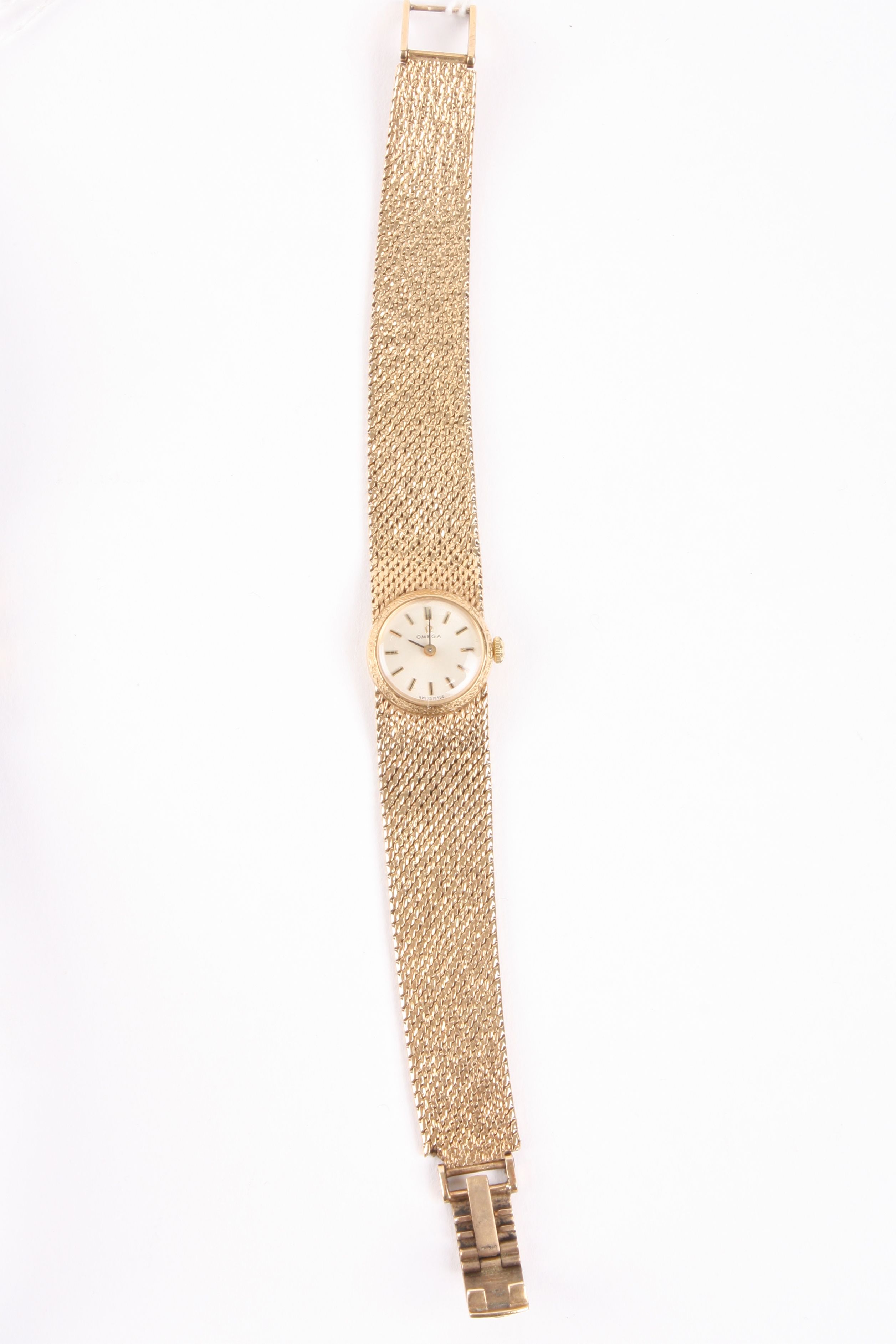A 9ct gold ladies Omega wrist watch
the circular dial with baton numerals, with a woven gold