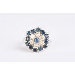 An 18ct white, sapphire and diamond cluster ring
set with central sapphire surrounded by six