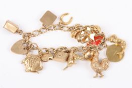 A 9ct gold charm bracelet with 17 charmsincluding a kangaroo, a cockerel and a ships lamp, with a