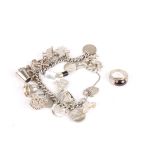 A heavy silver curb link charm bracelet
set with numerous novelty charms, together with a silver