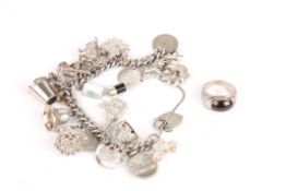 A heavy silver curb link charm braceletset with numerous novelty charms, together with a silver