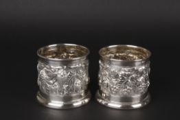A pair of Continental .800 silver wine bottle holderswith repoussé floral decoration, the bases