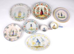 A collection of Quimper potteryincluding a variety of plates, dishes and bowels, most of the plates