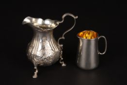 A Victorian embossed silver cream jughallmarked London 1839, supported on three hoof feet, together