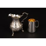 A Victorian embossed silver cream jug
hallmarked London 1839, supported on three hoof feet, together