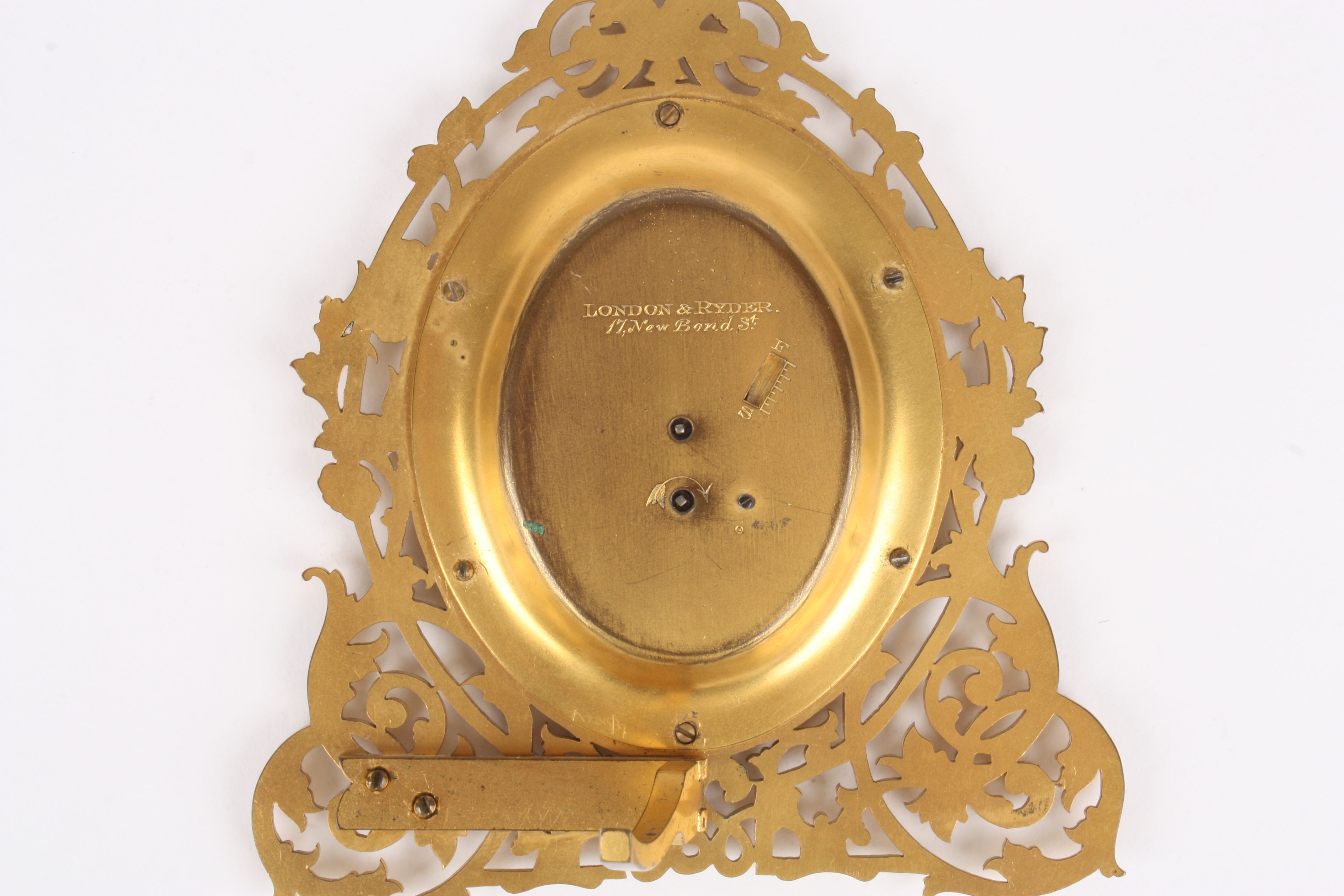 A Victorian gilt metal easel clock by London & Ryder
the engraved oval silvered dial with blued - Image 4 of 4