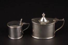 Two Victorian silver mustard pots with blue glass linersone of oval form, hallmarked London 1900,